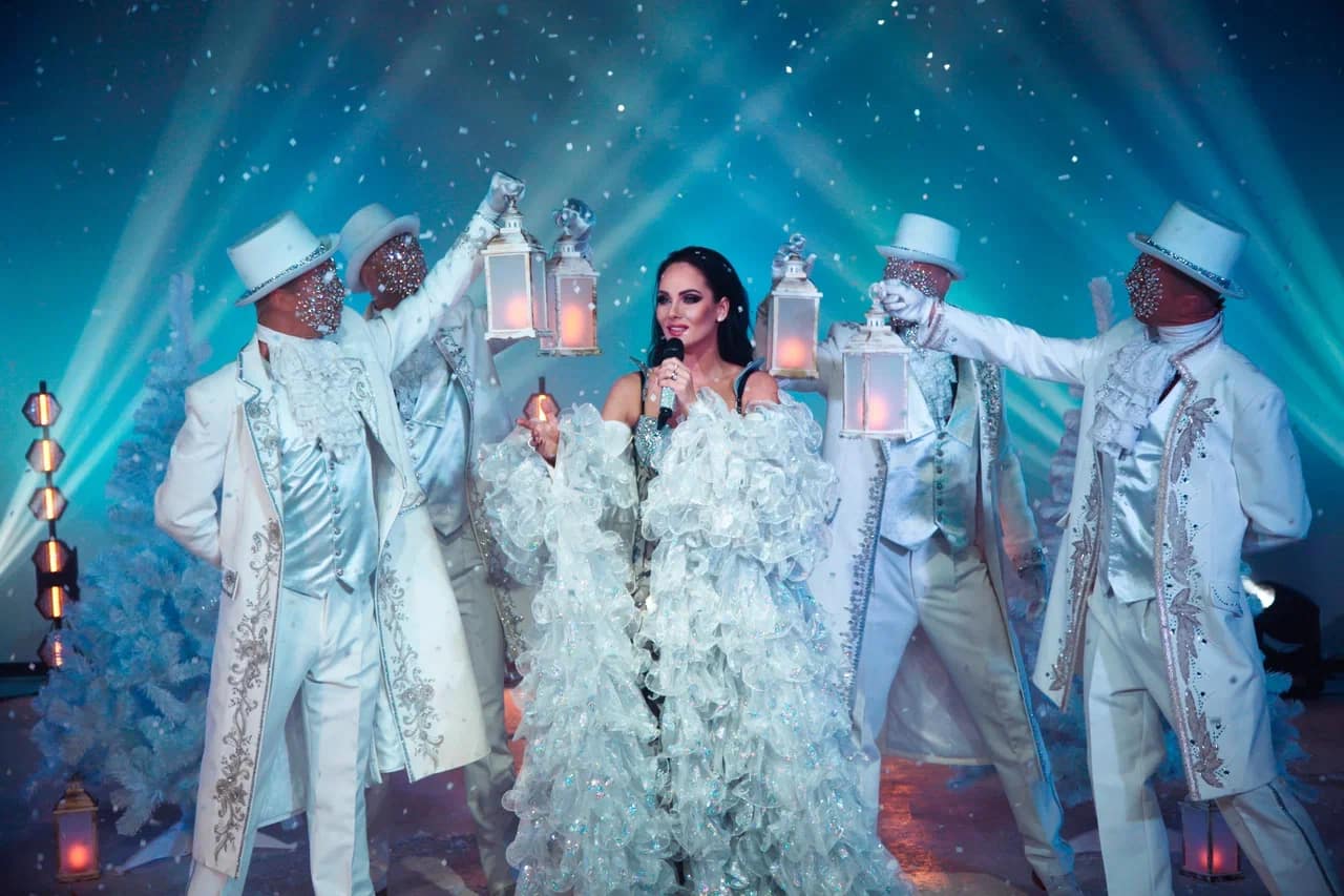 Performers with lanterns in white costume at a New Year show in Dubai
