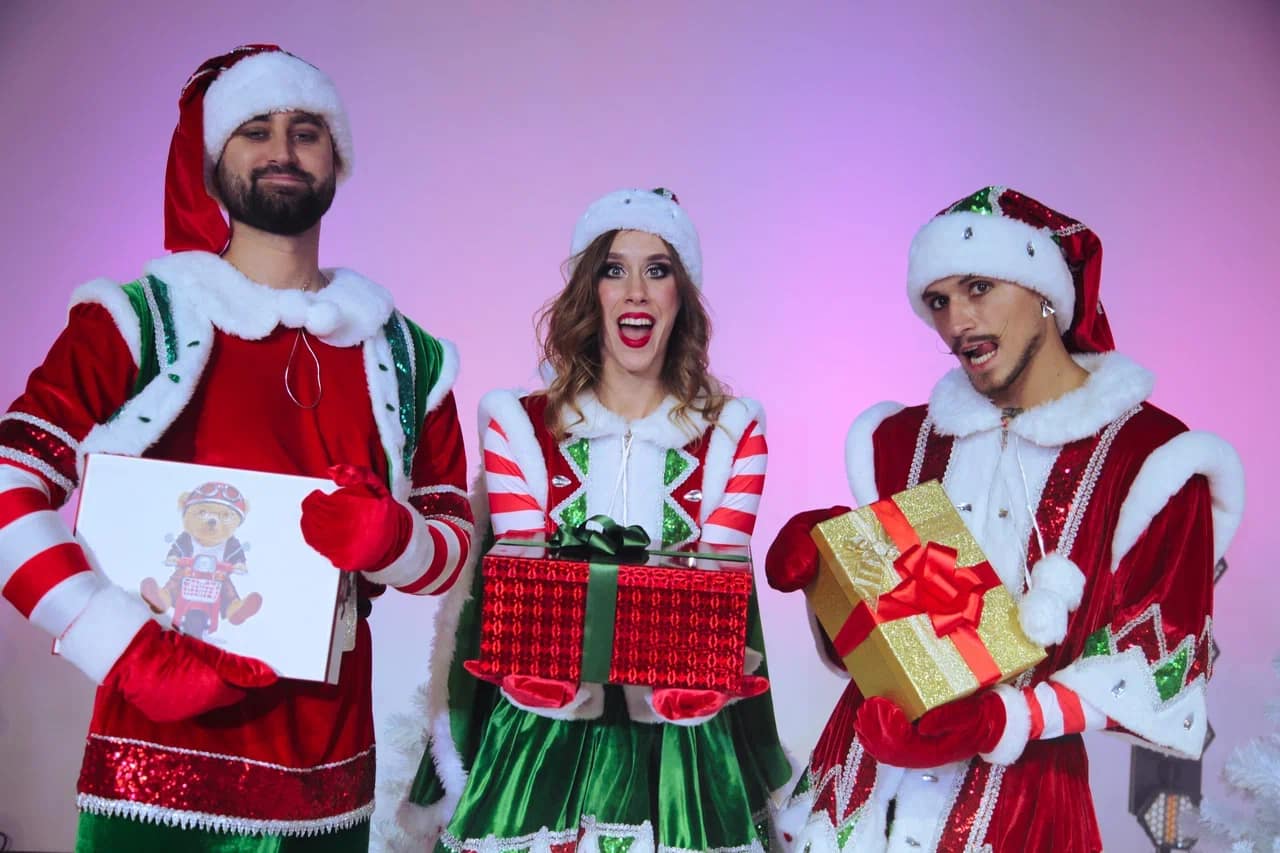 Performers in elf costume with gift boxes at a New Year show